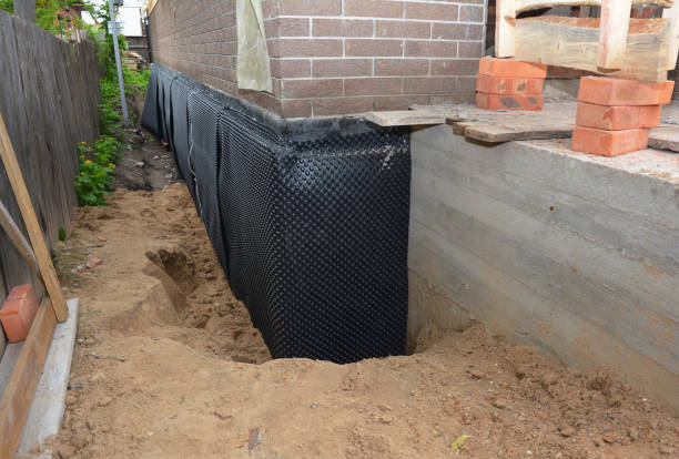 Happy homeowners after waterproofing job in Ostrander